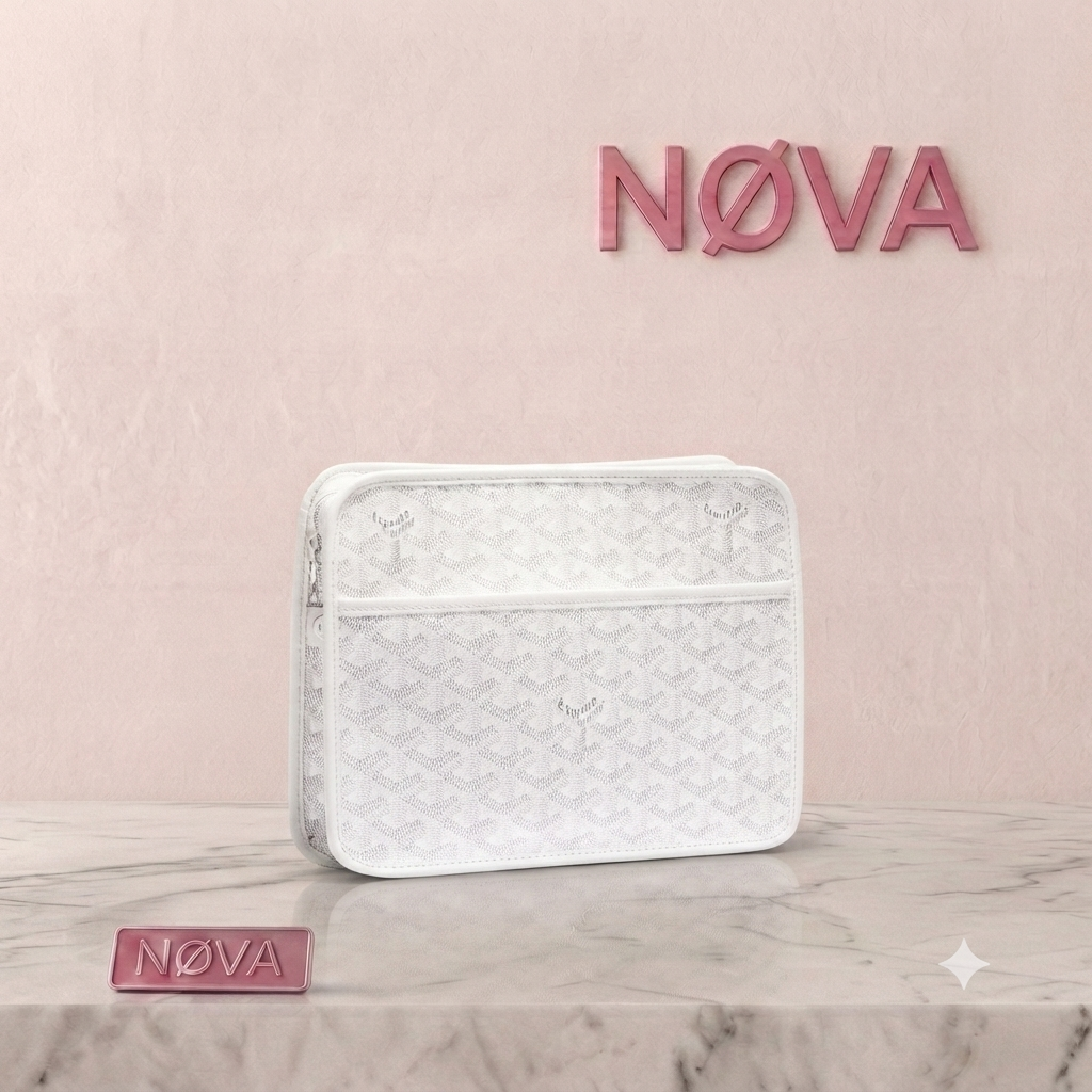 White Goyard Jouvence toiletry bag with textured pattern and zipper closure, placed on a marble surface.